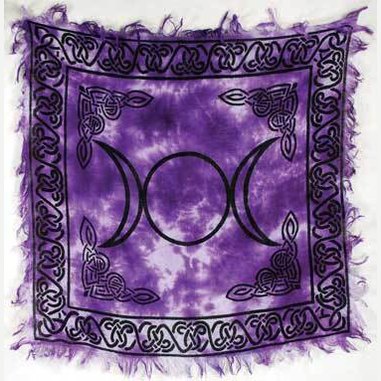 Purple tapestry with a triple moon symbol and Celtic knot designs.
