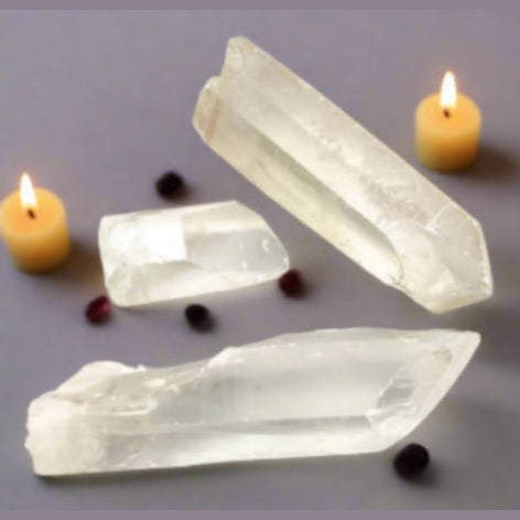 Three crystal or mineral specimens on a light gray background