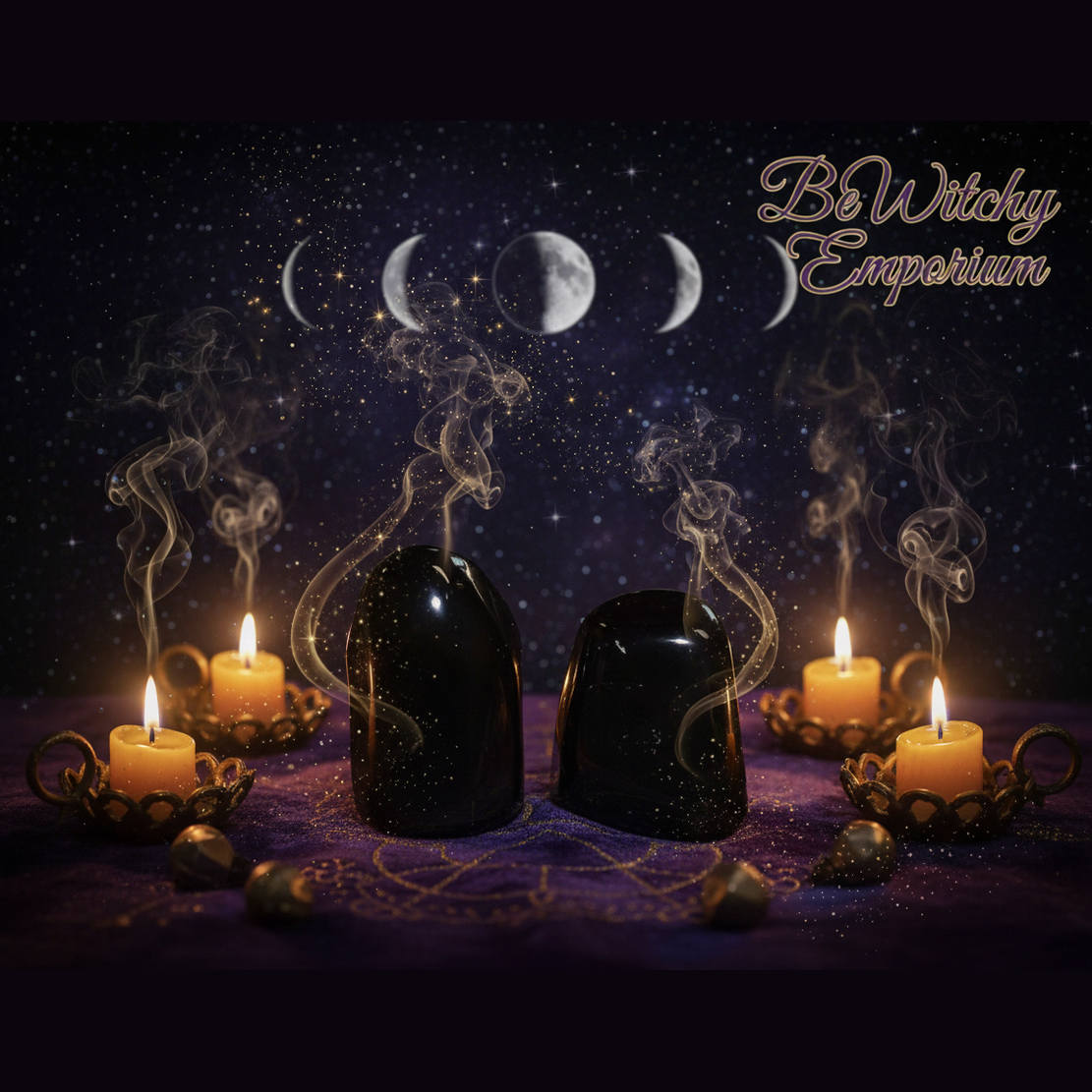 Exact pair of polished black obsidian stones with professional mystical protection atmosphere